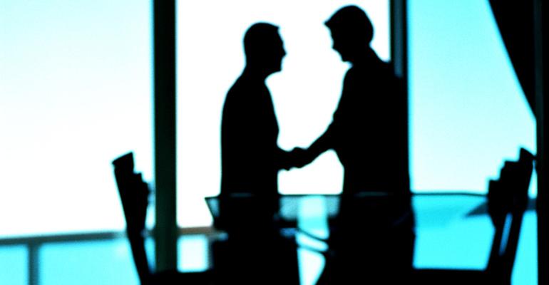 businessmen handshake silhouetted business transition partner