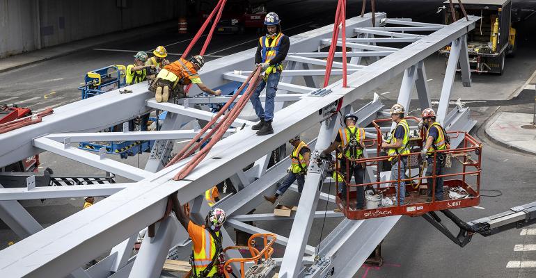 construction workers building a bridge infrastructure Fed rates