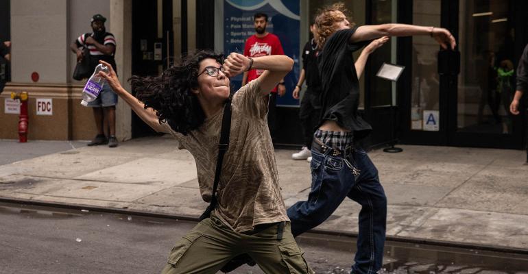 social unrest protestors throwing water bottles