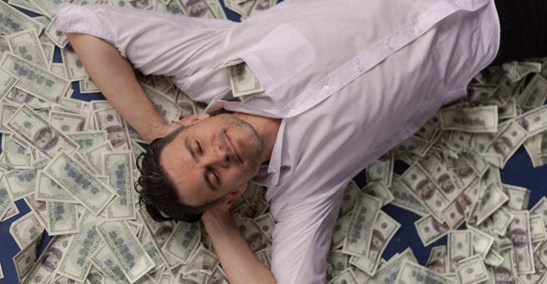sleeping on bed of $100 bills