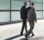 businessmen-walking-embrace.jpg