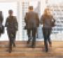 group of young businessmen and women running up stairs pro bono work