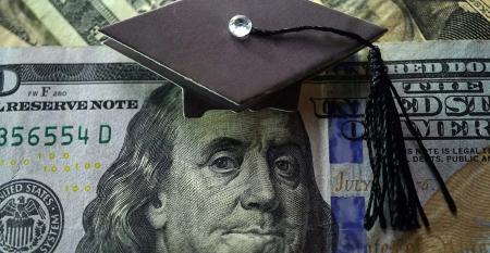 graduation cap on dollar ROI academic programs